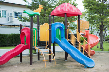 Colorful children playground on yard in the village.
