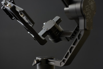 Close-up of gimbal stabilizer, with low-key lighting and a black background