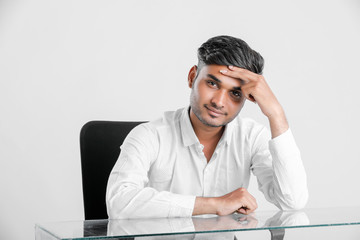 young indian  stressed  employee working at office.