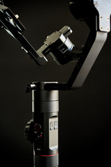 Close-up of gimbal stabilizer, with low-key lighting and a black background