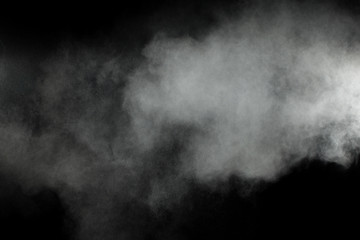 White powder explosion clouds.Freeze motion of white dust particles on black background.