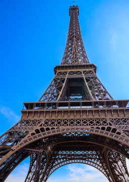 Eiffel Tower against blue sky with clouds in Paris, France. April 2019