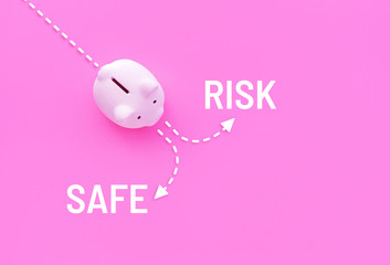 Piggy bank with risk and safe text on pink pastel color background