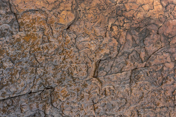 Natural background. Texture of brown sandstone smoothed by water
