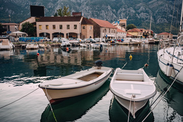Fototapeta na wymiar Two boats in harbor of Kotor