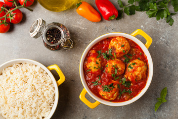 Chicken meatballs with tomato sauce. Served with rice.