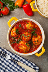 Chicken meatballs with tomato sauce. Served with rice.