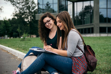 Two college students studying outside