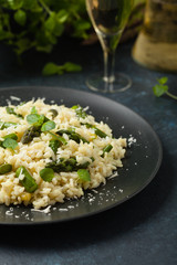 Classic Italian risotto with asparagus. Front view. Darkblue background.