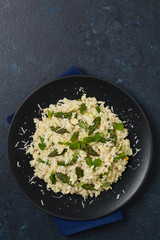 Classic Italian risotto with asparagus. Top view. Darkblue background.