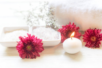 Obraz na płótnie Canvas Aromatherapy Spa with candle and red flower spa and rolled towel. Thai Spa relax Treatments and massage white background, select focus. Healthy Concept.