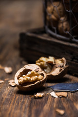 Peeled walnut and opener on rustic table