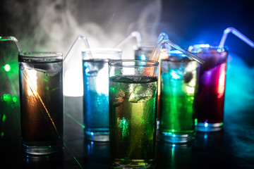 collection of colorful shots with lemon on bar; set of alcohol mini cocktail shooters with lime;
