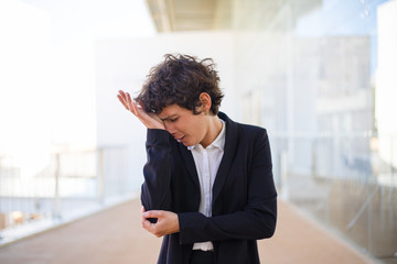 Upset businesswoman crying. Middle aged businesswoman in formal wear standing with hand on face and crying. Emotion concept