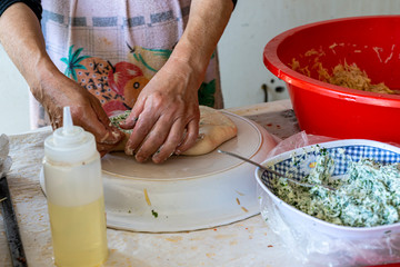 Preparing stuffed pita with labaneh and hyssop