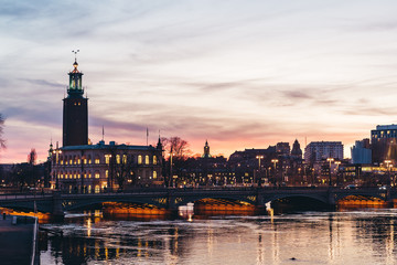Obraz premium Stockholm city at the evening with the sun setting and the street lights are on, Sweden