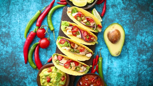 Mexican taco with chicken meat, jalapeno, fresh vegetables served with guacamole
