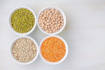 Various legumes in small bowls. Mash, chickpeas, lentils, quinoa