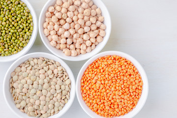 Various legumes in small bowls. Mash, chickpeas, lentils, quinoa