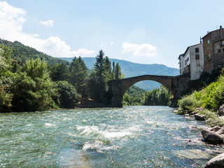 Romanesque bridge with a single arch, in Gerri de la Sal, on the Noguera Pallaresa river. Catalan Pyrenees. Catalonia, Spain.
