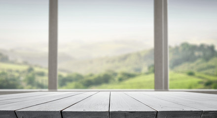 Table background with wooden table top for an advertising product. tress, forest and gardens outside the house.