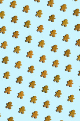 Gingerbread cookie photo pattern on light blue background. Christmas concept.