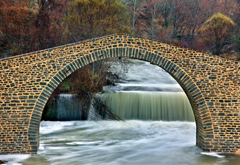 The stone arched bridge of Paleomagero river, close to Dasyllio village, Voio mountain, Grevena prefecture, Western Macedonia, Greece.