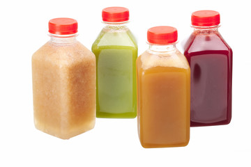 Fake fruit or vegetable juices in plastic bottles isolated on white background.