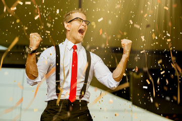 successful caucasian businessman white shirt and red tie hand up victory goal achieve with paper shoot confetti color tone