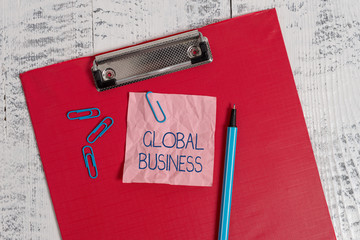 Writing note showing Global Business. Business concept for Trade and business system a company doing across the world Colored clipboard crushed sticky note clip marker old wooden background