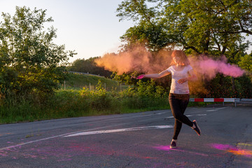 Happy young woman enveloped in a cloud of powder