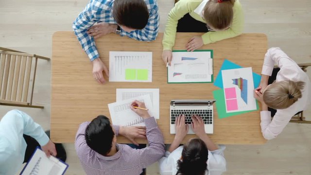 Group of multiethnic busy people working in an office, top view