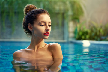 Retreat and vacation.. Beautiful young woman relaxing in spa swimming pool.