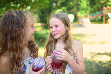Young friends drink lemonade on a hot day