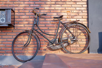 Fototapeta na wymiar Retro bicycle against brick wall.