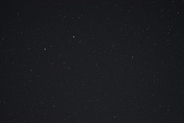 Night sky low light photo. A lot of stars and constellations on dark sky. Stock photo of deep sky. Far away from city and no clouds.