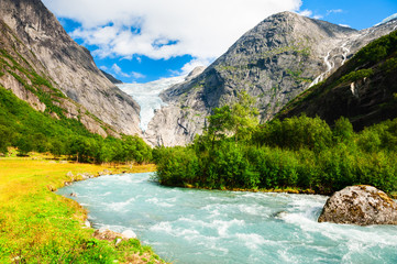 Briksdal glacier and mountain river in Jostedalsbreen national reserve, Norway. Summer landscape....