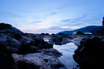 Obraz premium Beautiful landscape with sea, stones and sunset sky.