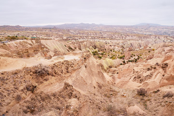 Travel and tourism in Turkey. Famous sightseeing Cappadocia, Anatolia. Beautiful landscape with mountains, caves and cloudy sky.