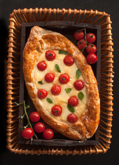 Traditional Turkish baked pide dish. Middle Eastern snacks. Turkish pizza. Pide with cheese. Open pie with cheese. The view from the top. Copy space.