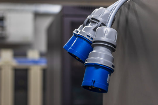 The power connector hangs from the data center rack. Electric power