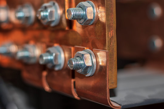Copper busbar. Nuts and bolts close-up.