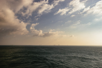 Obraz premium Isolated section of dark ocean water under clouds