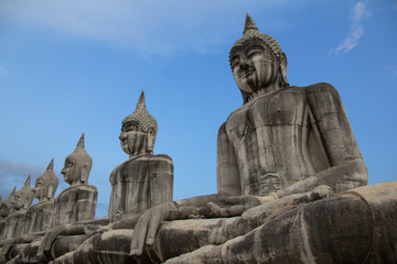 Fototapeta na wymiar Buddha face in blue sky background, Buddha statue in Thailand.