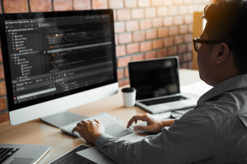 Asian man working code program developer computer web development working design software on desk...