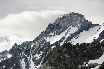 Beautiful black summit in clouds. Mountain landscape. Sofia top, Caucasus Mountains in Karachay-Cherkerssia, Russia.