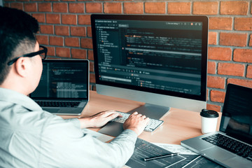 Asian man working code program developer computer web development working design software on desk...