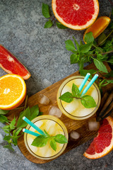 Grapefruit and orange gin cocktail or margarita, refreshing drink with ice. Top view flat lay. Free space for your text.