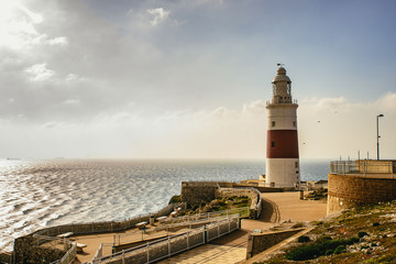 Lighthouse on wharf overlooking lake in daytime
