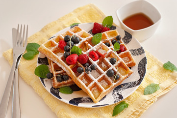 Belgian waffles with fresh berries and maple syrop